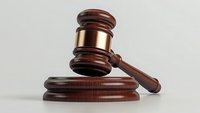 Wooden judge gavel with copper band and sound block on light background, symbol of law, justice and legal proceedings in courts and auctions.