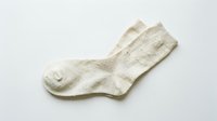 Pair of cream knitted cotton socks isolated on white background, casual everyday footwear with natural texture, perfect for fashion and retail use.