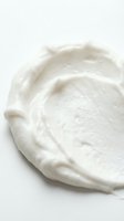 Creamy white whipped texture with soft swirls on neutral background, isolated and ready for cosmetics, skincare, dairy, and food packaging design use.