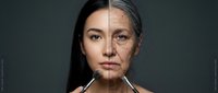 Split face portrait showing aging process from young to elderly woman with wrinkles and gray hair transformation concept for skincare and time passage.