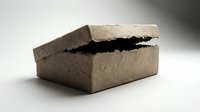 Cracked brown cardboard box with torn edges on neutral background showing damage and wear for packaging and shipping concepts.