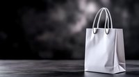 White paper shopping bag with handles on dark background for retail marketing and commercial branding projects.