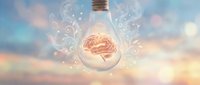 Glowing brain inside light bulb with swirling golden particles and bokeh background, representing creativity, innovation, and intellectual ideas for design projects.