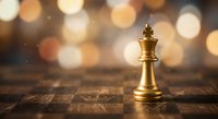 Golden chess king piece standing on wooden chessboard with warm bokeh lights background symbolizing leadership strategy and victory in business competition.