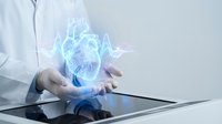 Medical professional using digital tablet displaying holographic human heart anatomy for cardiology healthcare technology and telemedicine consultation.