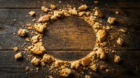 Gold nuggets and dust arranged in circle on dark wooden surface, symbolizing wealth, mining, and precious metals for finance and investment concepts.