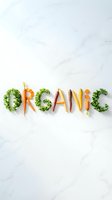 Word organic spelled with fresh vegetables including kale and colorful carrots on white marble surface, flat lay food art concept.