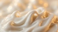 Luxurious white cream with golden highlights flowing in elegant waves. Smooth texture perfect for skincare, cosmetics and beauty product advertising.