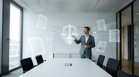 Professional businessman presenting legal concepts with digital justice scales and documents in modern conference room for corporate law consultation.