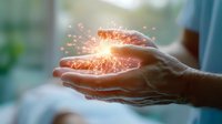 Elderly hands holding glowing energy sphere with sparkling light particles, concept of healing power and spiritual energy.