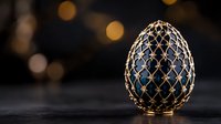 Luxurious decorative egg with golden lattice pattern on dark blue enamel surface against blurred bokeh background, elegant royal design with intricate metalwork detail.