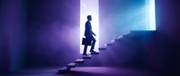 Silhouette of male professional climbing stairs toward bright light, representing career advancement, success, and business growth opportunities.