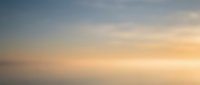 Soft gradient sky background with warm pastel colors transitioning from blue to orange, creating peaceful atmospheric mood for web design and presentations.