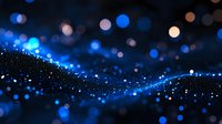 Glowing blue particles and bokeh lights create magical wave pattern against dark background, abstract defocused sparkles for festive designs.
