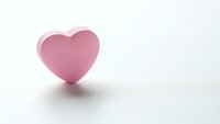 Pink heart shape on white background with soft shadow, romantic symbol for love, Valentine's Day, wedding, greeting cards and relationship concepts.