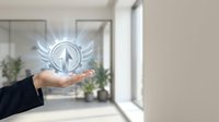 Businessman hand holding glowing compass icon with wings in modern office space, representing navigation, direction, and business guidance for corporate solutions.