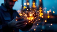 Businessman holding glowing magical light sparks in cupped hands with bokeh lights background at dusk for innovation and creativity concepts.