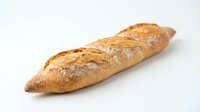 Fresh baguette bread loaf with golden crust isolated on white background for bakery and food design projects.
