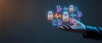 Healthcare professional holding glowing neon medical icons including pills, heartbeat, DNA, and health monitoring symbols on dark background for telemedicine and digital health concepts.