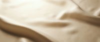 Soft beige fabric with gentle folds and natural texture, suitable for backgrounds, textile design, and interior styling projects.