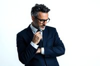 Mature businessman with gray hair and glasses in navy suit thinking thoughtfully against white background, professional corporate portrait.