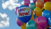 Colorful party balloons against blue sky with clouds, featuring promotional call-to-action message. Focus on central blue balloon with text, surrounded by yellow, orange, pink and turquoise balloons.