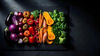 Fresh organic vegetables arranged in wooden tray on dark background for healthy cooking and meal preparation.