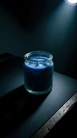 Glass jar with dark blue liquid under dramatic spotlight creating moody atmosphere for laboratory research and scientific experiments.