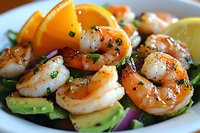 Grilled shrimp salad with fresh avocado slices, citrus wedges and herbs on white plate, close up view showing juicy texture and appetizing garnish.