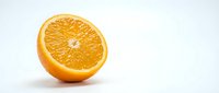 Fresh orange half cut in half showing juicy citrus flesh and segments, isolated on white background for food and beverage design use.