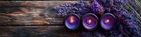 Purple aromatic candles with fresh lavender flowers on rustic wooden background, creating relaxing spa atmosphere for wellness and meditation practice.