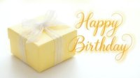 Happy Birthday greeting card with yellow gift box and elegant golden calligraphy script on soft light background for celebration.
