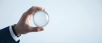 Businessman holding crystal ball against light background, symbolizing future vision, business strategy, and predictive analysis for corporate planning.