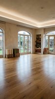 Empty modern living room with hardwood floors, arched windows, built-in shelving and natural lighting for interior design and real estate.