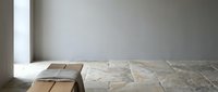 Minimalist interior with natural marble floor and wooden cube furniture in soft daylight creating serene modern living space for contemporary design.