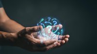 Open hand holding glowing blue question marks against dark background, representing confusion, uncertainty, problem solving, and decision making concepts for business and technology design.