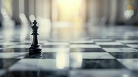Black chess king piece standing alone on checkered board with dramatic lighting and shallow depth of field creating atmospheric business strategy concept.