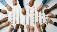 Diverse group of people arranging coins in rows on white surface, representing financial planning, savings, budgeting, teamwork, and collaborative money management for business or educational purposes.