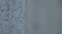 Modern concrete wall texture with speckled surface pattern and smooth gray background for architectural design projects.