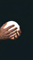 Male hands holding glowing orb against dark background, symbolizing innovation, energy, and future technology concepts for business and creative projects.