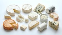 Assorted gourmet cheese collection featuring brie, camembert, blue cheese, goat cheese and aged varieties isolated on white background for culinary design.