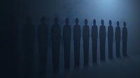 Dark silhouettes of standing figures in mysterious foggy atmosphere with dramatic backlighting create eerie, supernatural mood for horror and mystery designs.