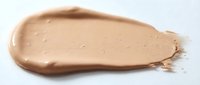 Creamy beige foundation makeup smear isolated on white background. Cosmetic product texture swatch for beauty and skincare applications.