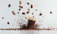 Levitating coffee beans and ground coffee powder creating dynamic composition with coffee cup on light background, splash effect for cafe menu design.