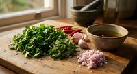 Fresh herbs and vegetables on wooden cutting board in rustic kitchen setting with natural window light for healthy cooking and meal preparation.