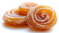 Orange spiral candy swirls dusted with sugar crystals on white background isolated for confectionery and dessert designs.
