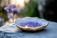 Purple amethyst geode slice with gold rim on stone surface, natural crystal formation for healing meditation spa decor and jewelry making crafts.