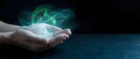 Hands holding glowing green digital network connections with futuristic holographic data visualization for technology and innovation concepts.