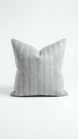 Gray herringbone throw pillow isolated on white background, showcasing textured woven fabric for modern home decor and interior design concepts.