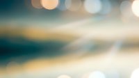 Abstract blurred background with warm bokeh lights and soft color gradients for modern design projects and creative presentations.